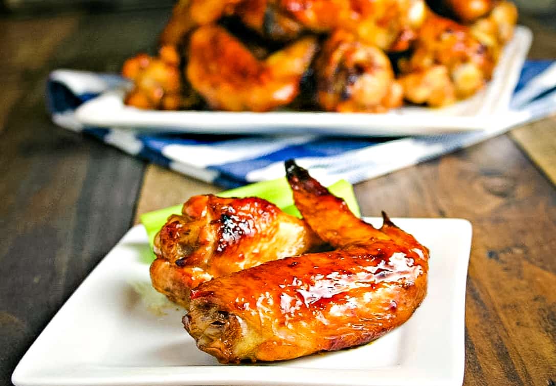 A plate of Sticky Baked Chicken Wings on a table