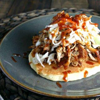 A plate of food with a fork, with Redneck Tacos and pulled pork