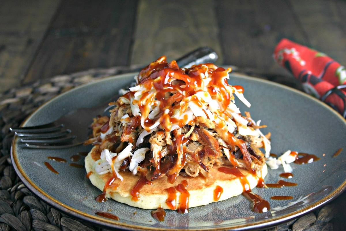 A plate of food with a fork, with Redneck Tacos and pulled pork