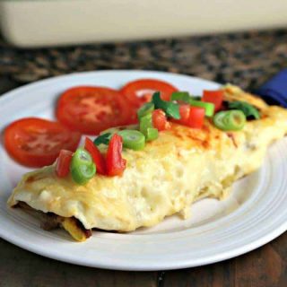 A plate of food on a table, with breakfast enchiladas