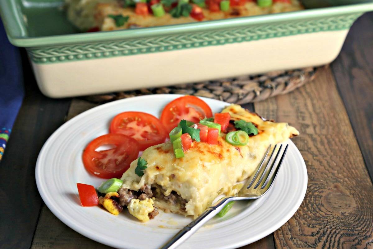 A plate of food on a table, with breakfast enchiladas