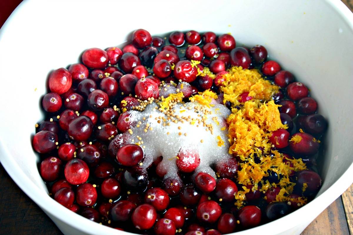 A pot of cranberries with sugar and orange zest, with Easy Cranberry Chutney