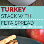 A sandwich cut in half on a plate, with Turkey Stack with Feta Spread