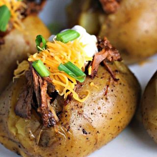 A close up of Slow Cooker Beefy BBQ Spuds, potatoes