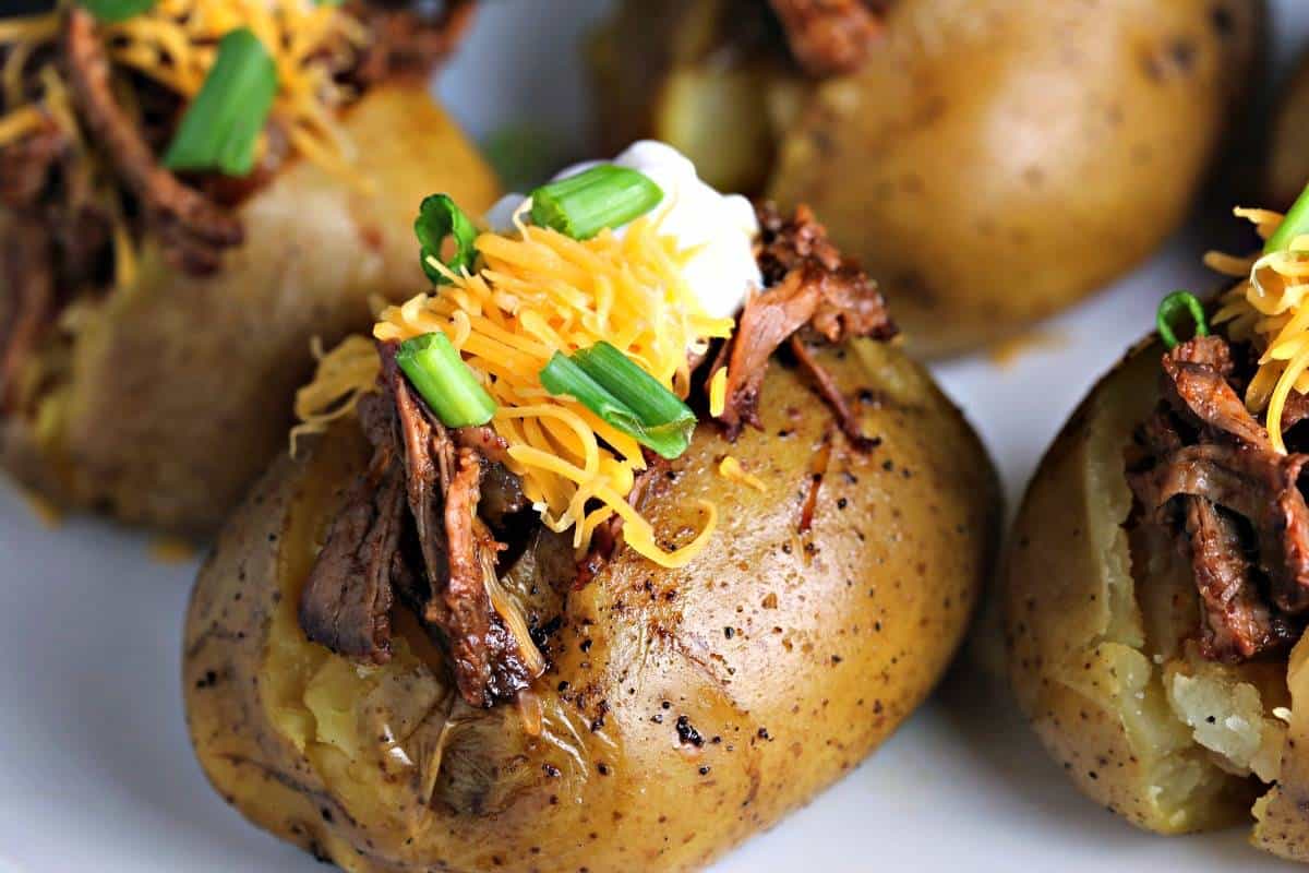 A close up of Slow Cooker Beefy BBQ Spuds, potatoes