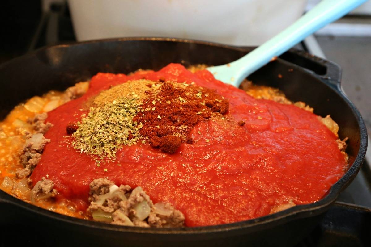 A close up of an iron skillet filled with Homemade Red Chili