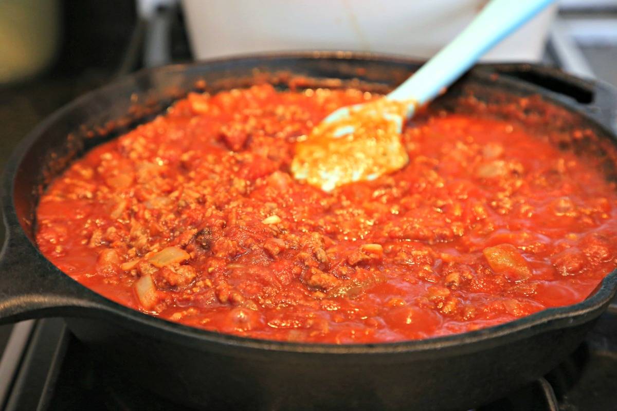 A close up of an iron skillet filled with Homemade Red Chili