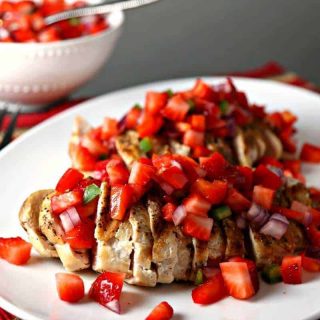 A plate of Grilled Chicken covered with Strawberry Salsa