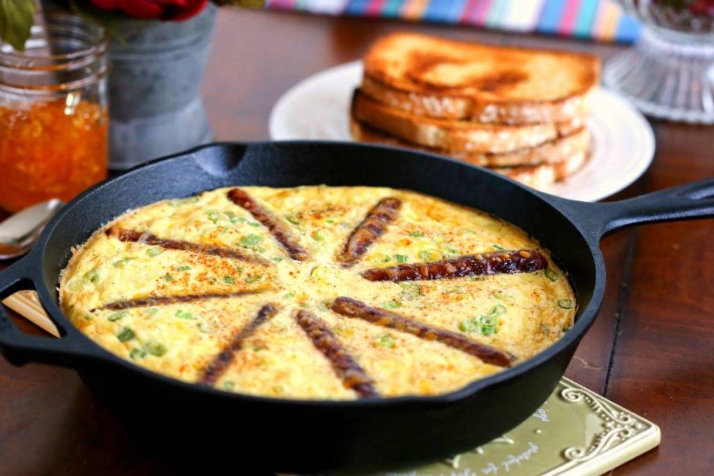 An iron skillet of Rustic Sausage and Grits Egg Skillet