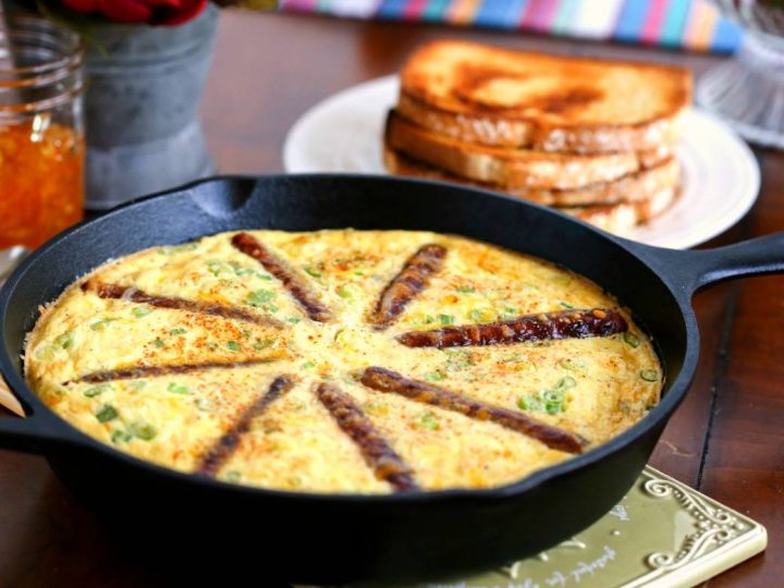 An iron skillet of Rustic Sausage and Grits Egg Skillet