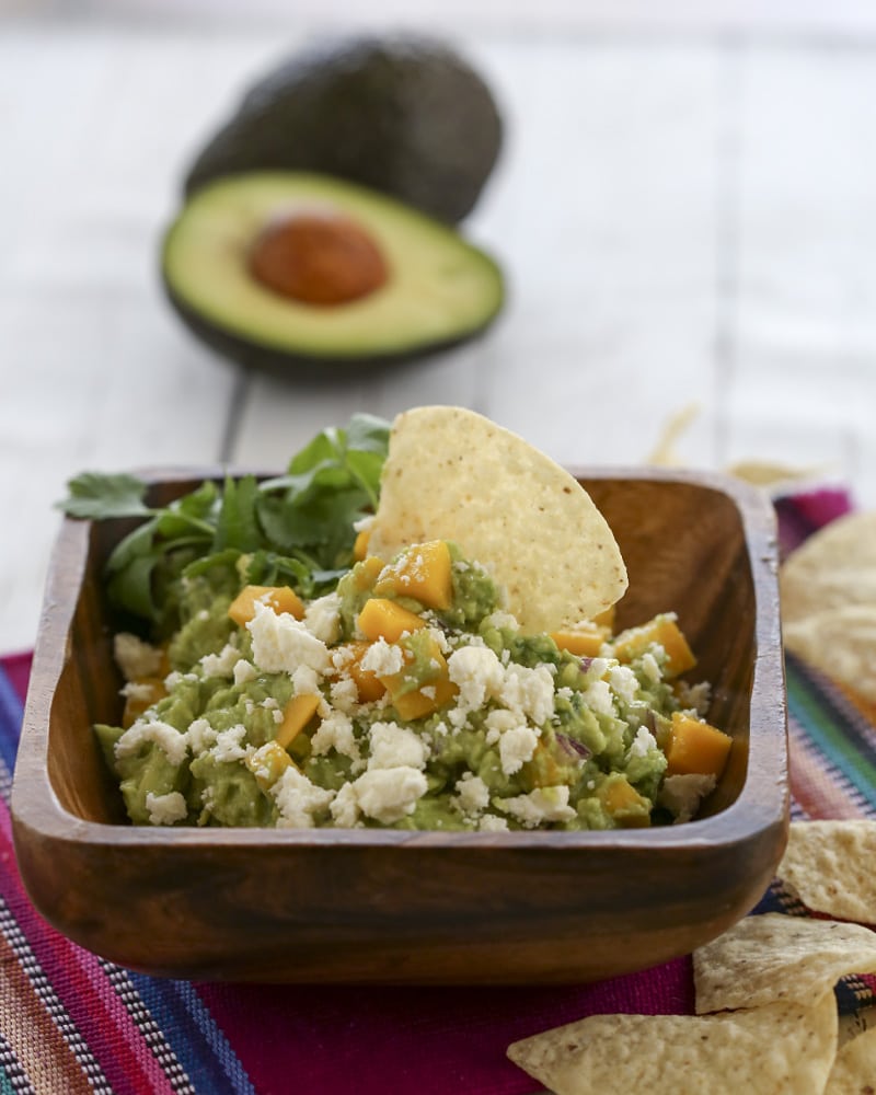 A close up of a bowl of mango guacamole
