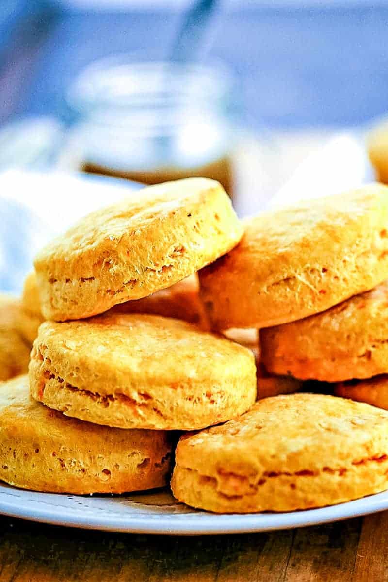 a stack of Buttery Sweet Potato Biscuits on a white plate