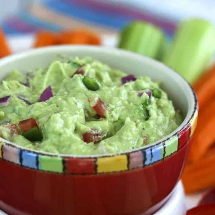 A close up of a bowl of food, with Guacamole