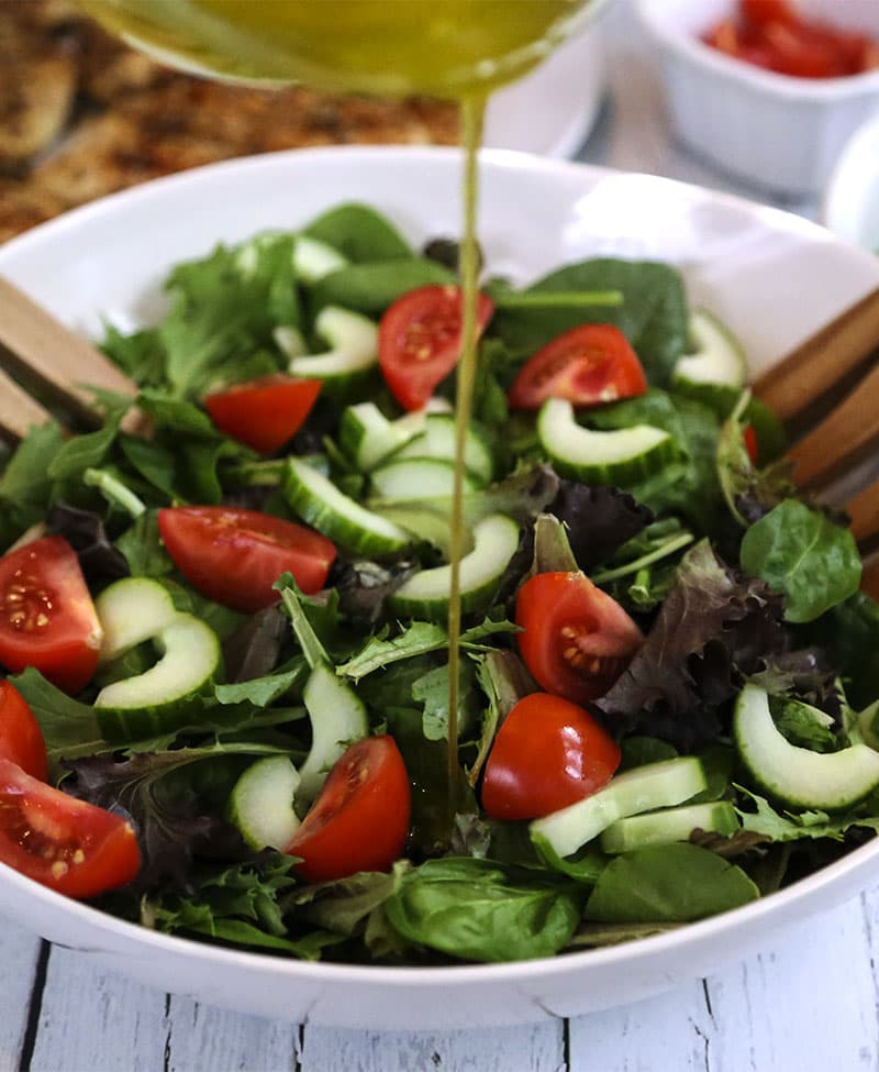 A bowl is filled with salad ingredients, with Sesame Chicken Salad