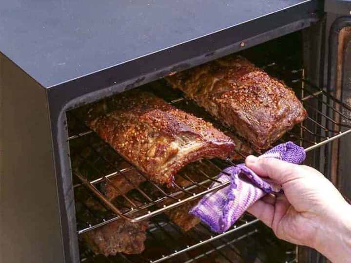 Food cooking in an electric smoker, with Smoked Baby Rack Ribs