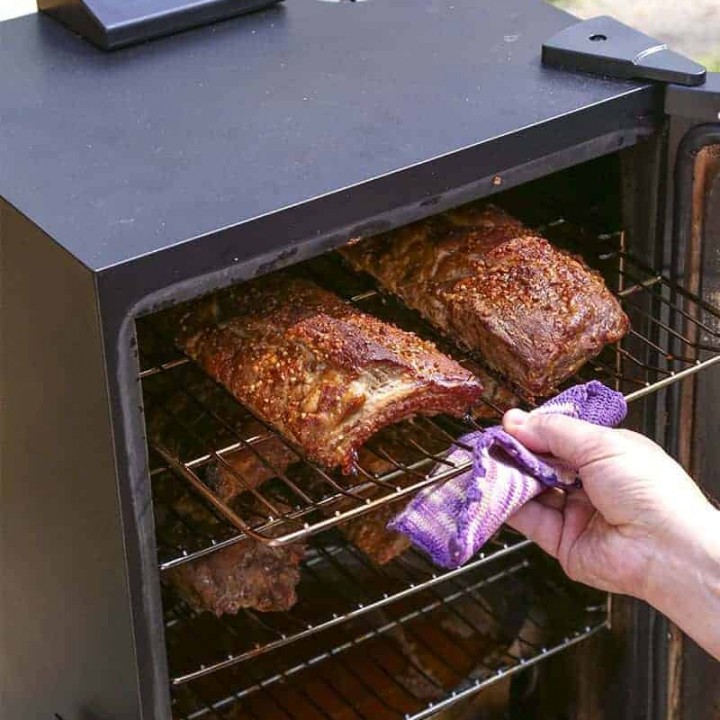 Food cooking in an electric smoker, with Smoked Baby Rack Ribs