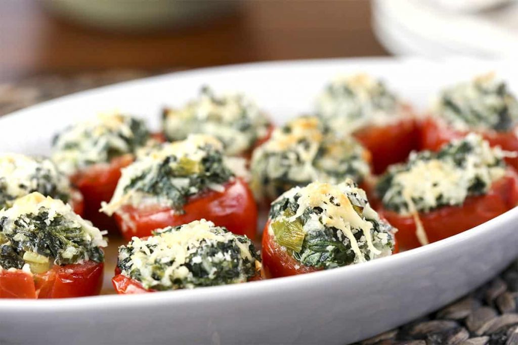 A close up of a plate of Spinach Stuffed Tomatoes