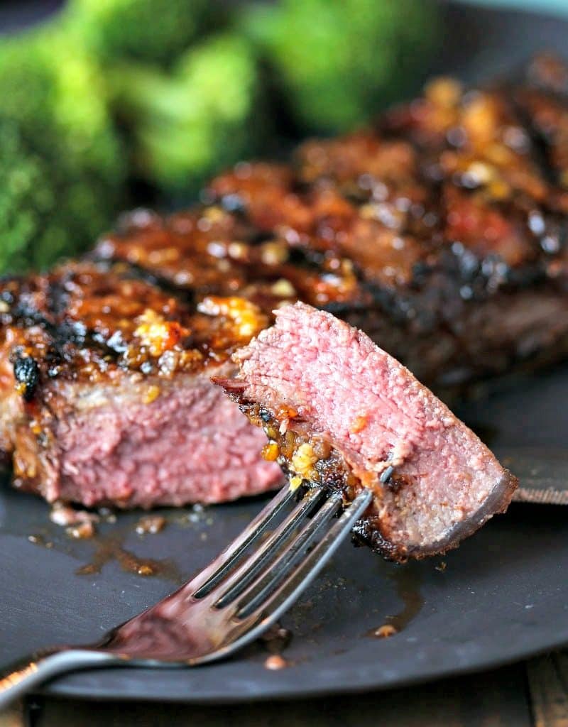 A close up of a bite of Mongolian Glazed Grilled Steak on a fork