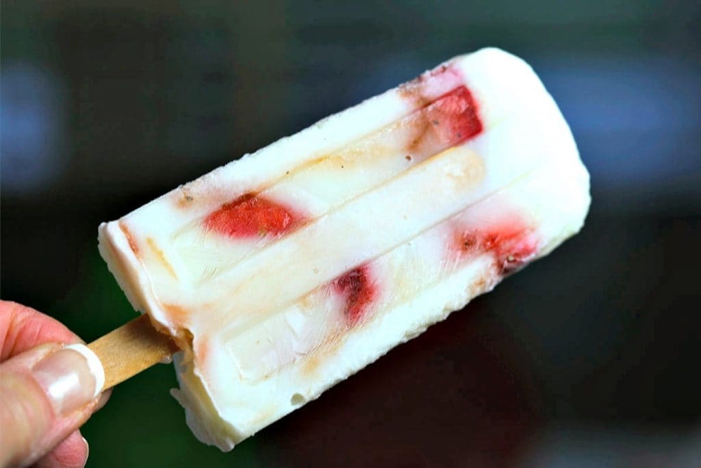 A close up of low fat strawberry vanilla yogurt pops