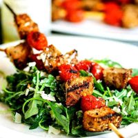 A plate of grilled panzanella skewer salad