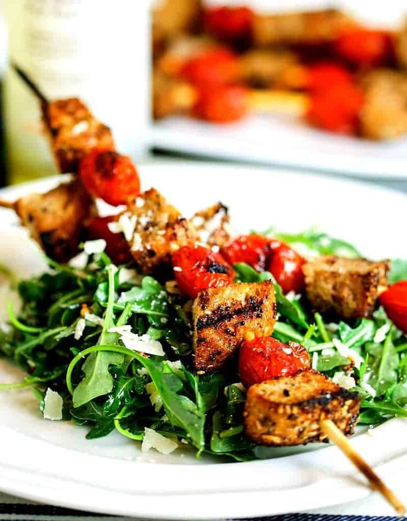 A plate of grilled panzanella skewer salad