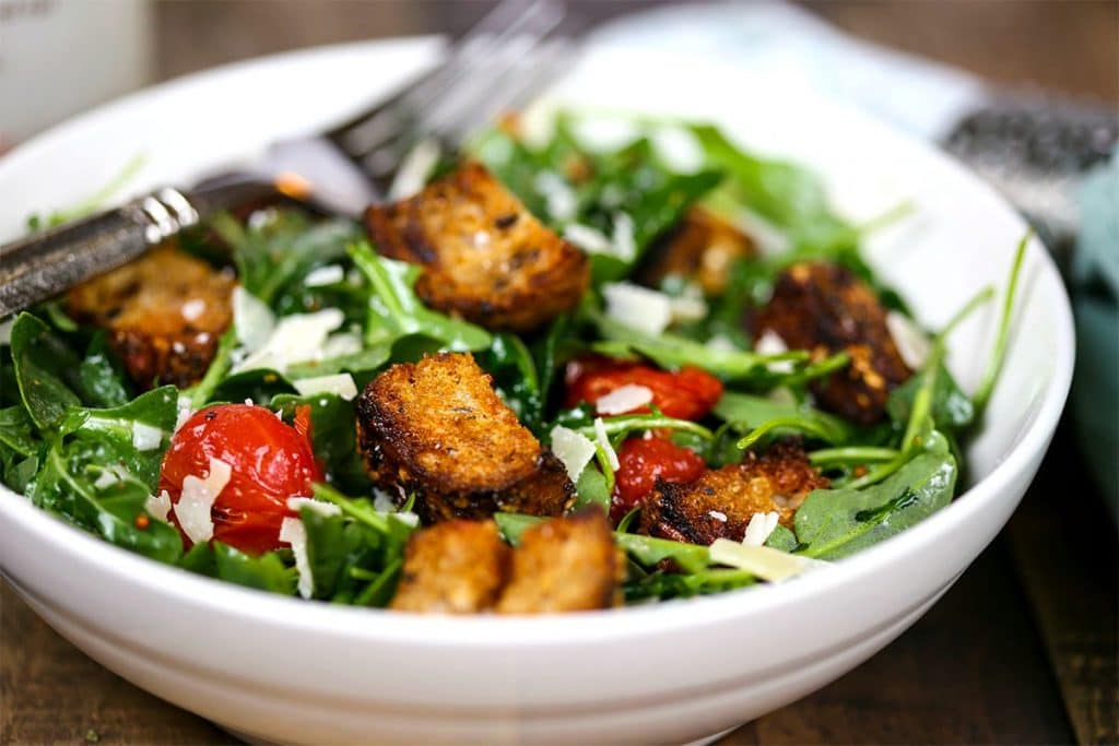 A bowl of grilled panzanella skewer salad