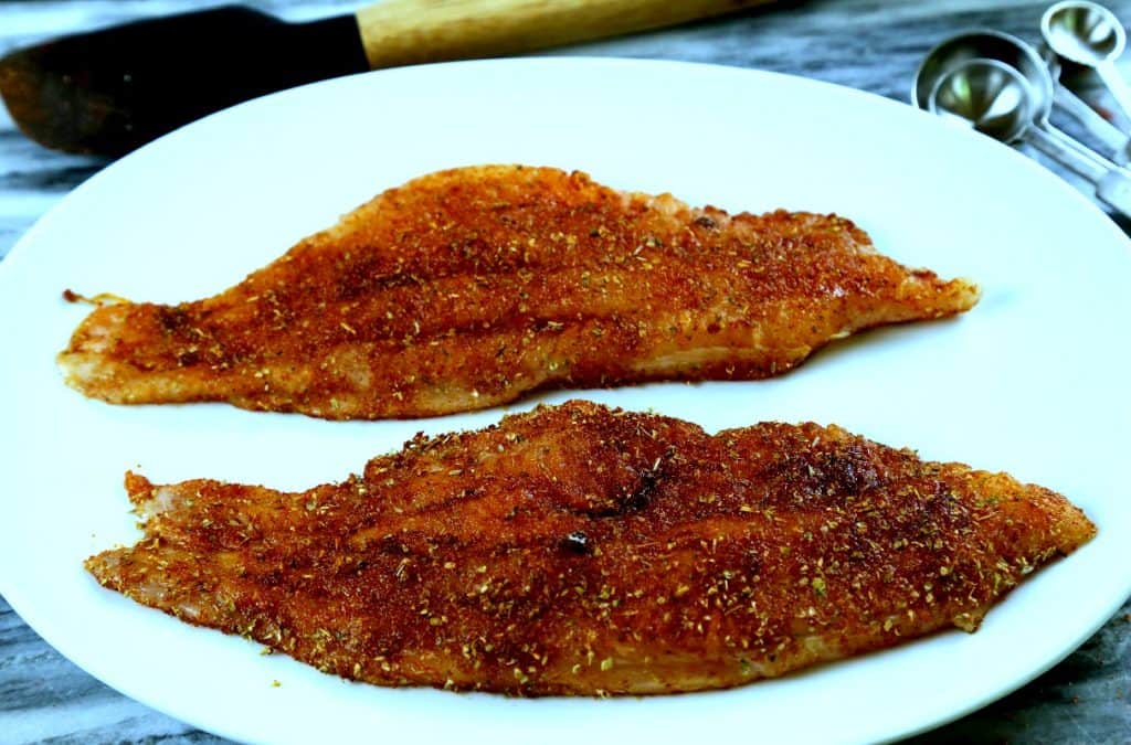 A plate of catfish with spicy rub ready to cook