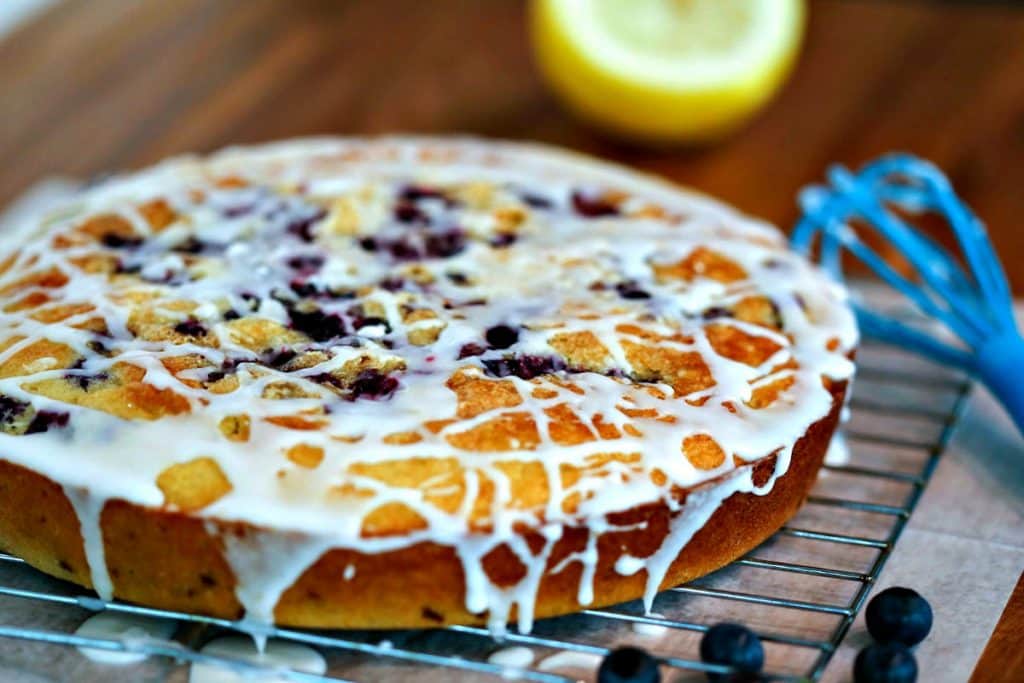 Blueberry Coffee Cake cooling on a wire rack on top of a wooden table