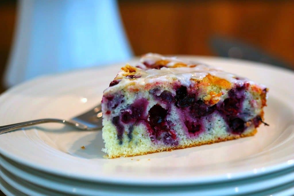 A close up of a slice of Blueberry Coffee Cake on a plate