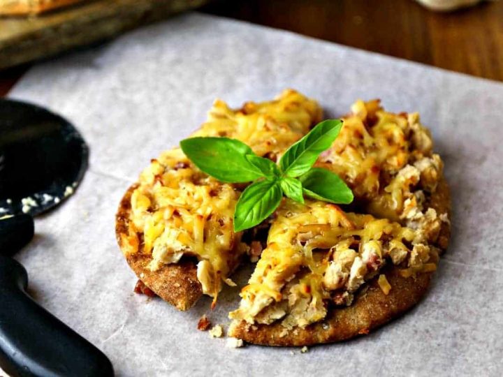 A slice of Smoked Gouda and White Bean Pizza sitting on top of a wooden table