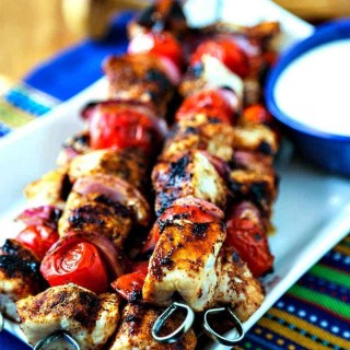 A plate of Smoky Chicken Kabobs on a table