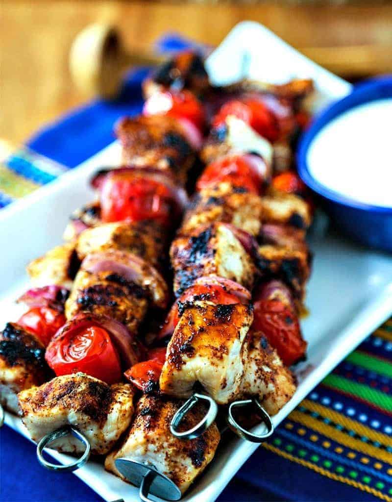 A plate of Smoky Chicken Kabobs on a table