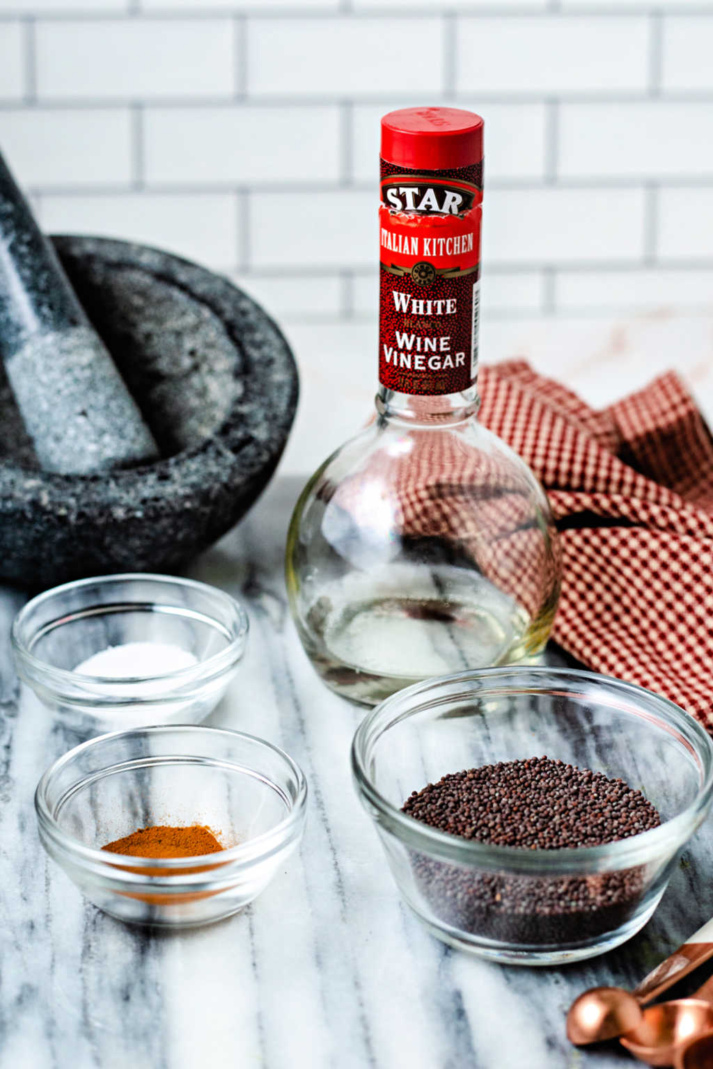 ingredients for homemade stone-ground mustard on a kitchen counter.