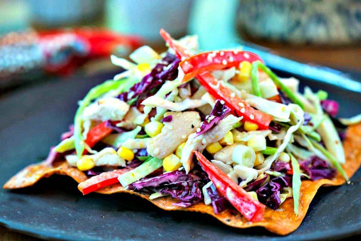 A close up of a plate of Asian Slaw with Egg Roll Crackers