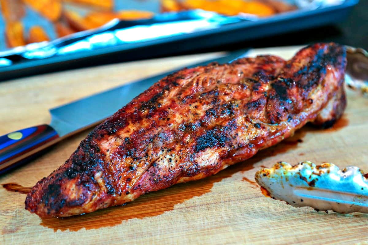 A close up of Chili-Orange Glazed Pork Tenderloin on a cutting board