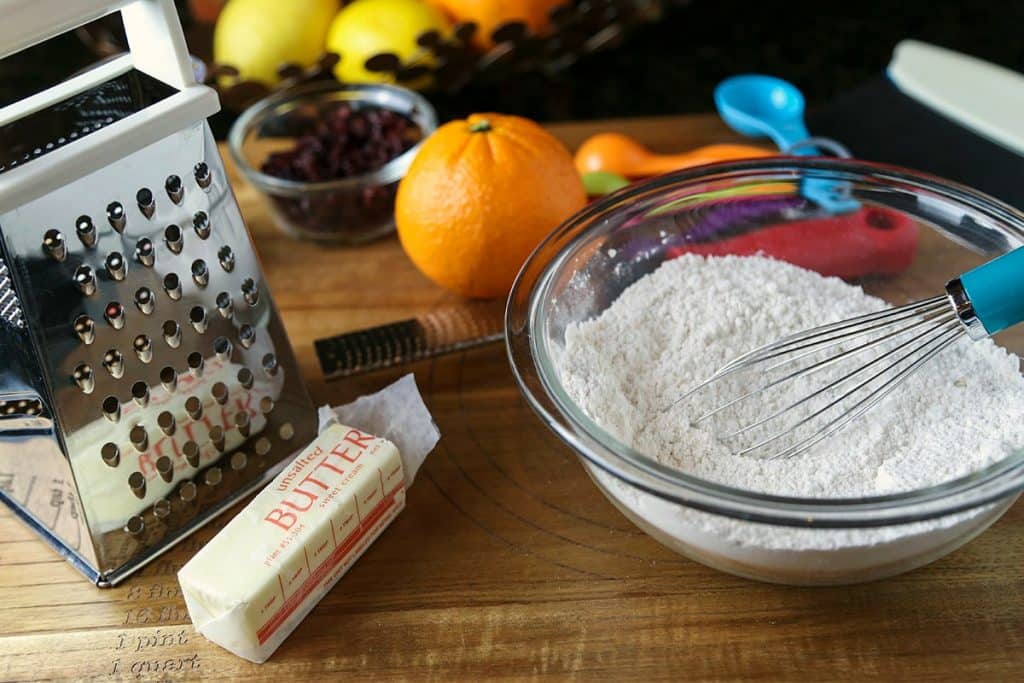 A bowl of flour and butter on a table