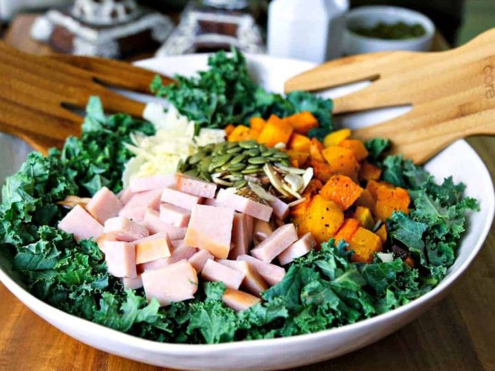 A bowl of autumn salad with butternut squash, turkey, and kale