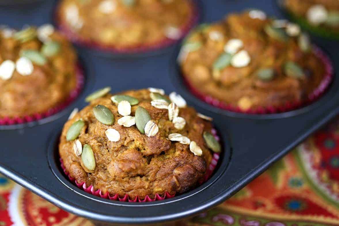 Pumpkin Oat Muffins in paper liners in a muffin pan