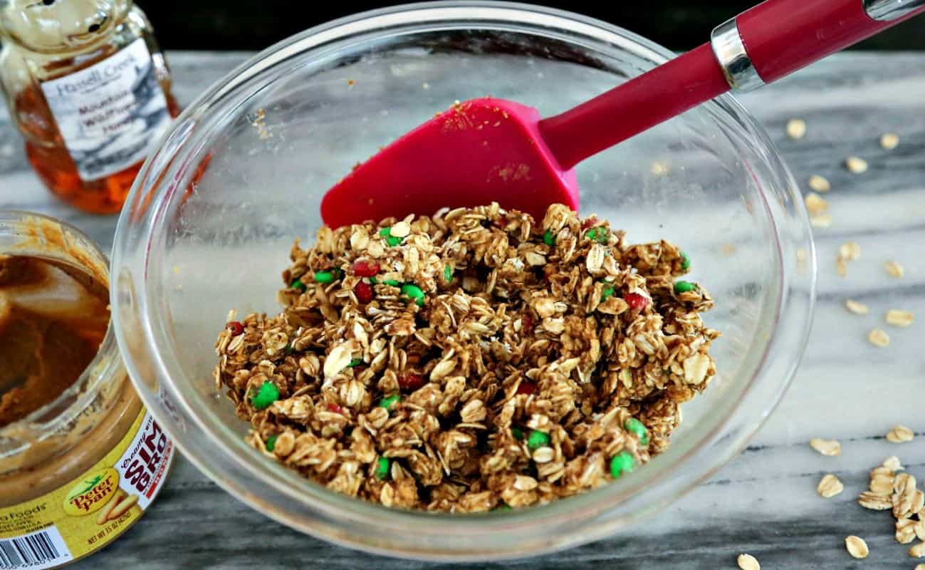Mixing ingredients in a bowl with a spatula for peanut butter oatmeal energy bites