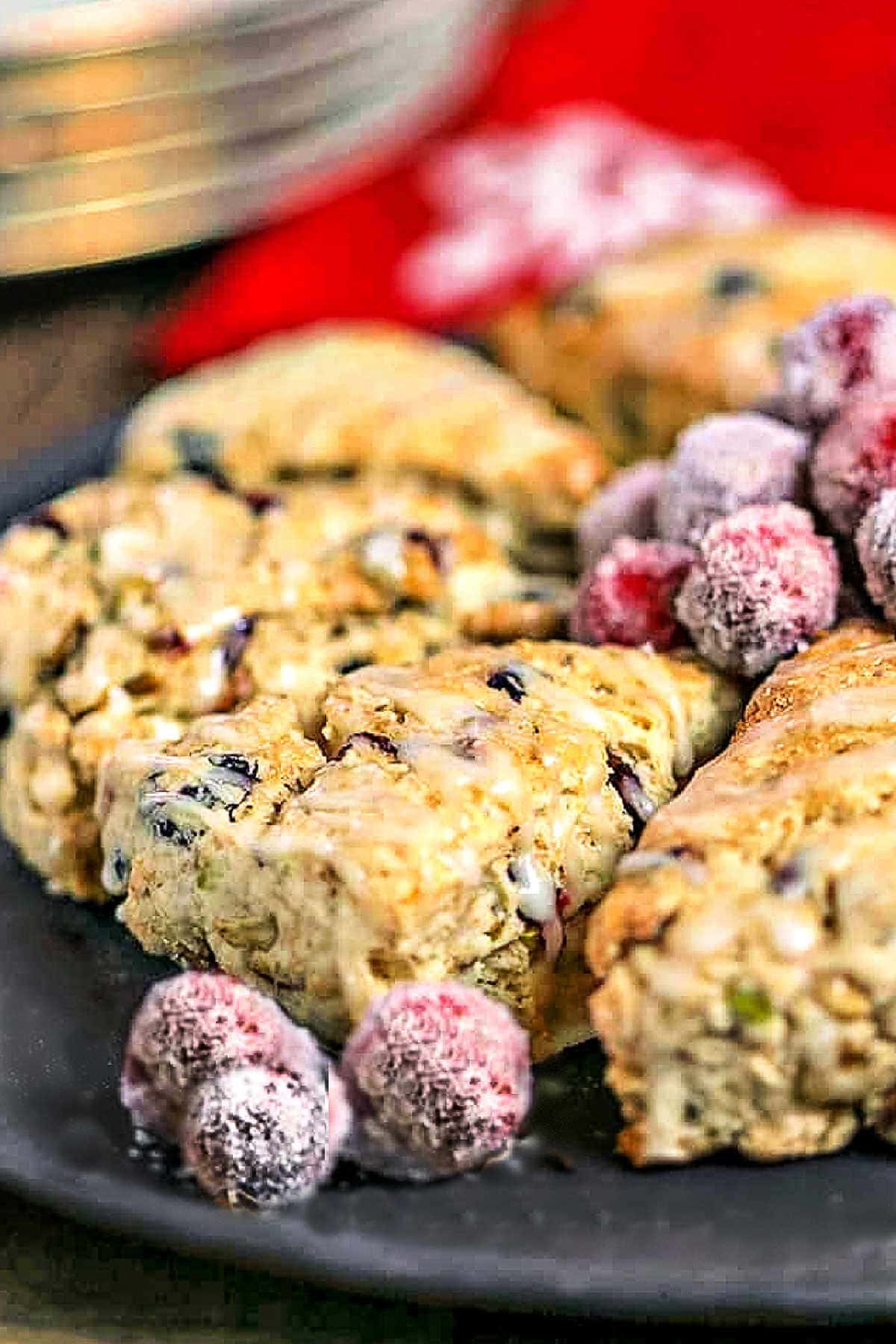 A close up of a cranberry pistachio scones on a plate