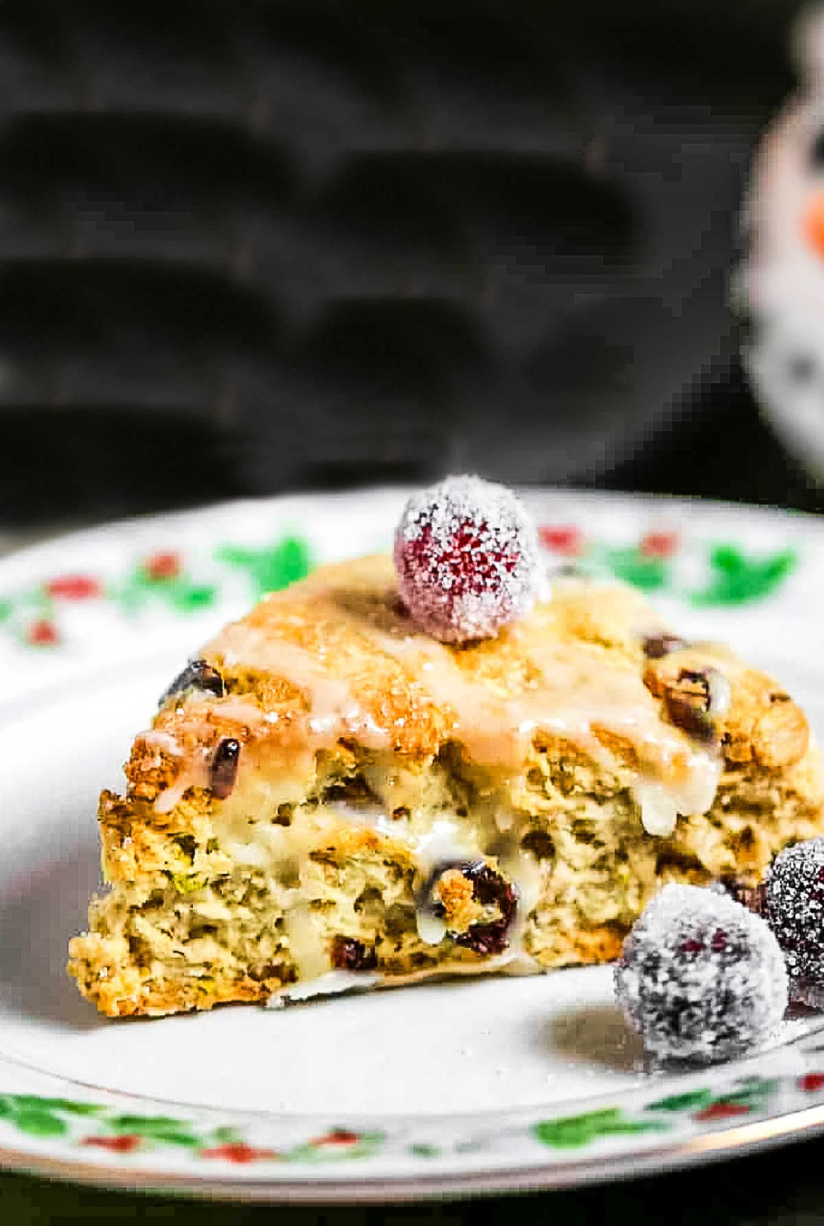 A close up of a cranberry pistachio scone on a plate