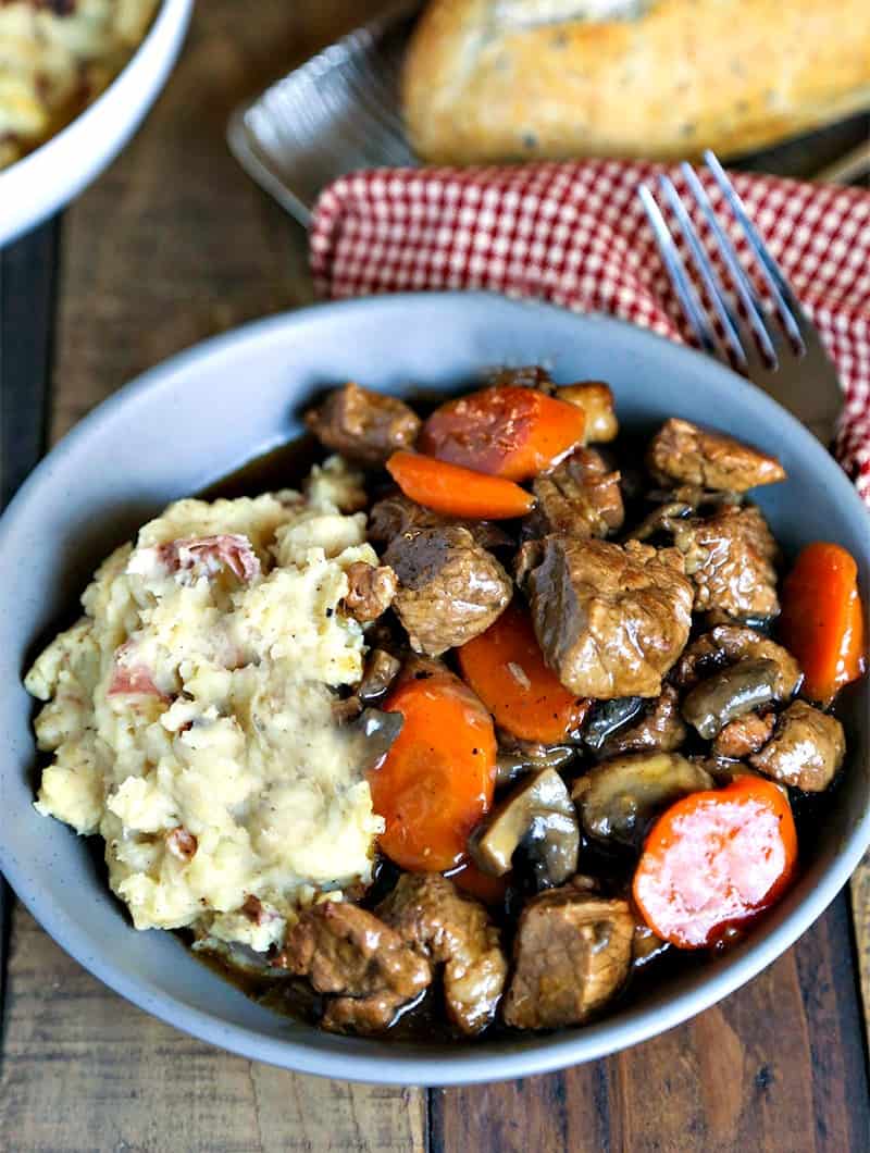 Marsala Beef Stew with Redskin Mashed Potatoes in blue bowl with fork