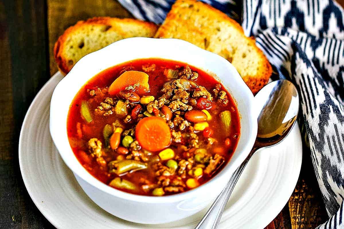 30-Minute Beefy Vegetable Soup in a white bowl with toasted bread