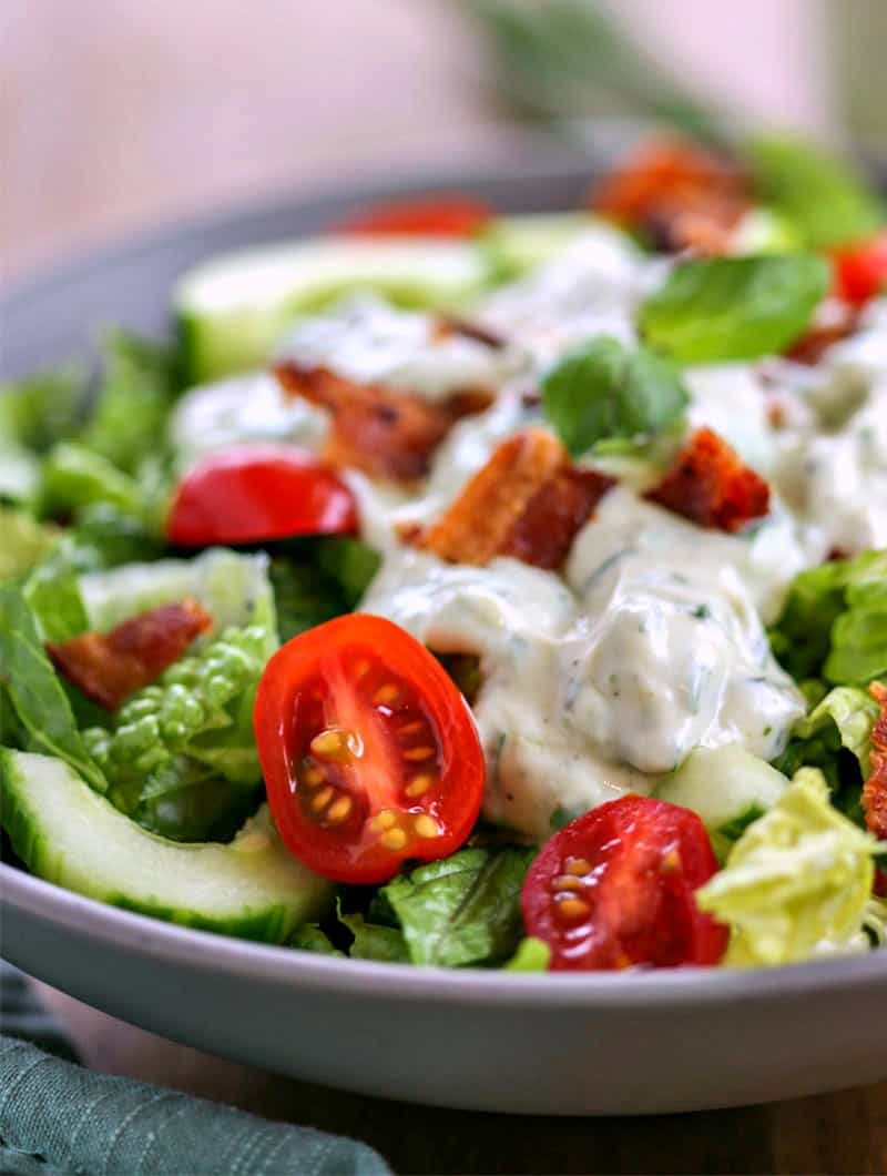 A bowl of salad, with Basil Buttermilk dressing
