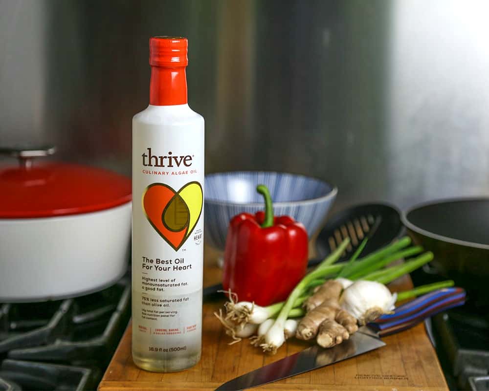 A close up of a bottle of Thrive Algae Oil on the counter