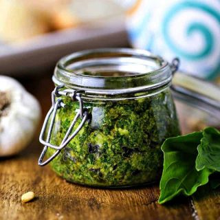 A close up of food on a table, with basil pesto spread