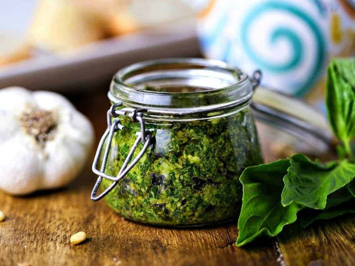 A close up of food on a table, with basil pesto spread