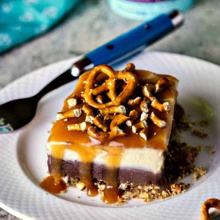 A piece of dark chocolate salted caramel ice cream cake on a plate