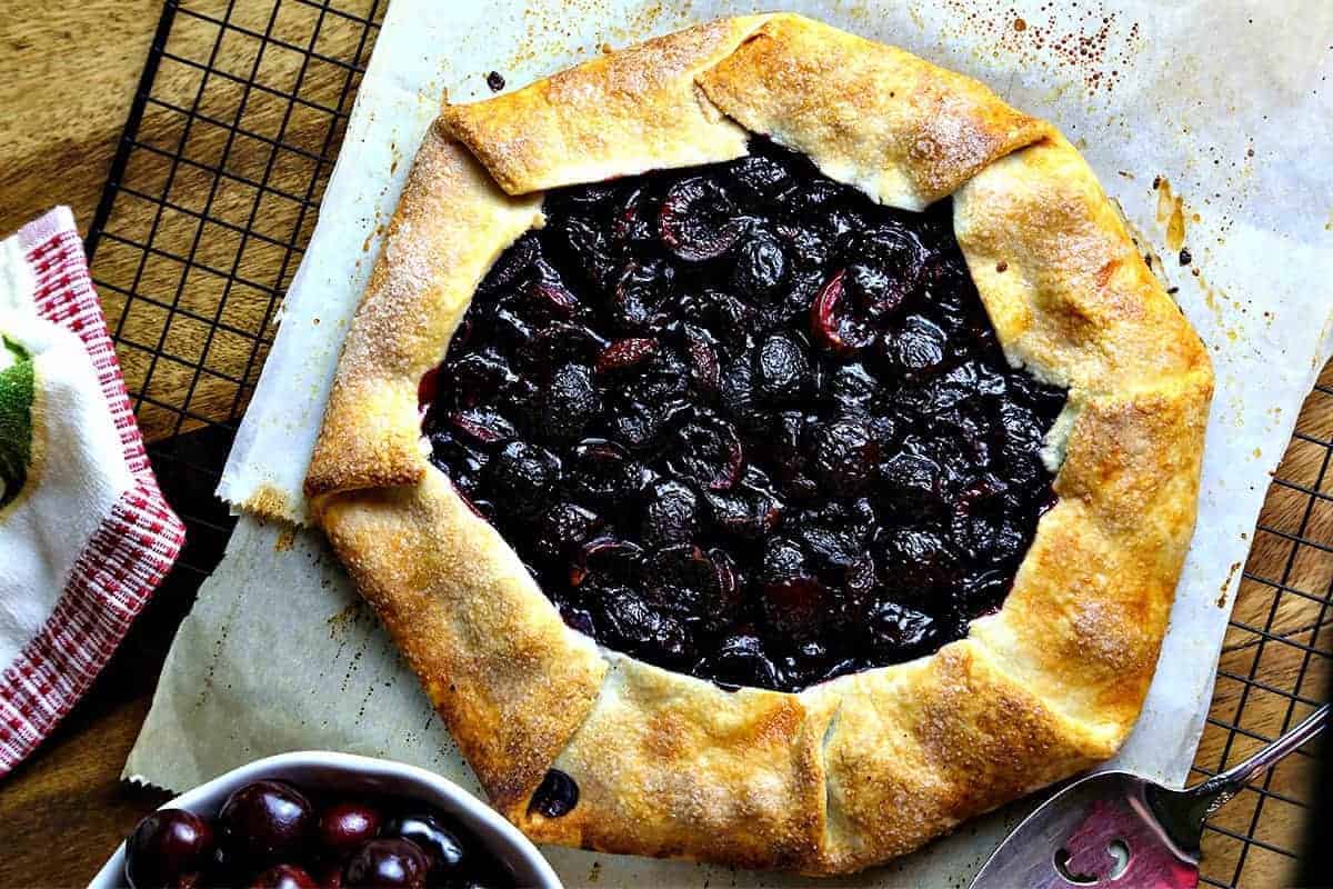 rustic cherry tart on parchment paper