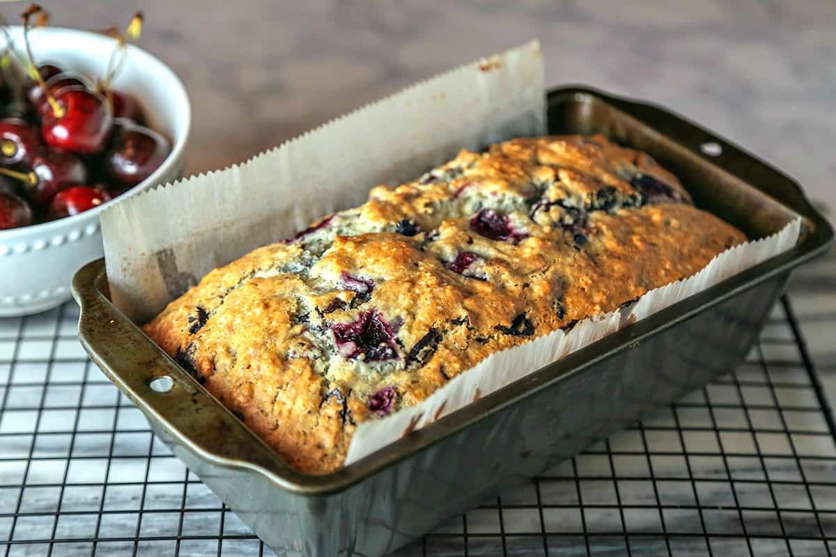 A baking loaf pan with cherry chocolate quick bread